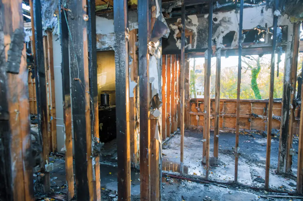 Fire damage inside a home with charred walls and heavy smoke residue