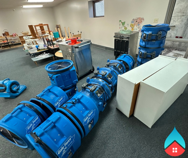 Water extraction equipment removing standing water from a flooded living space