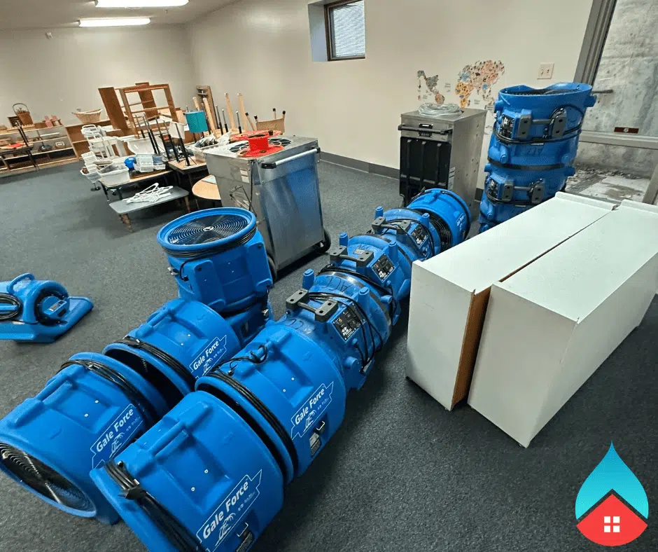 Water extraction equipment removing standing water from a flooded living space