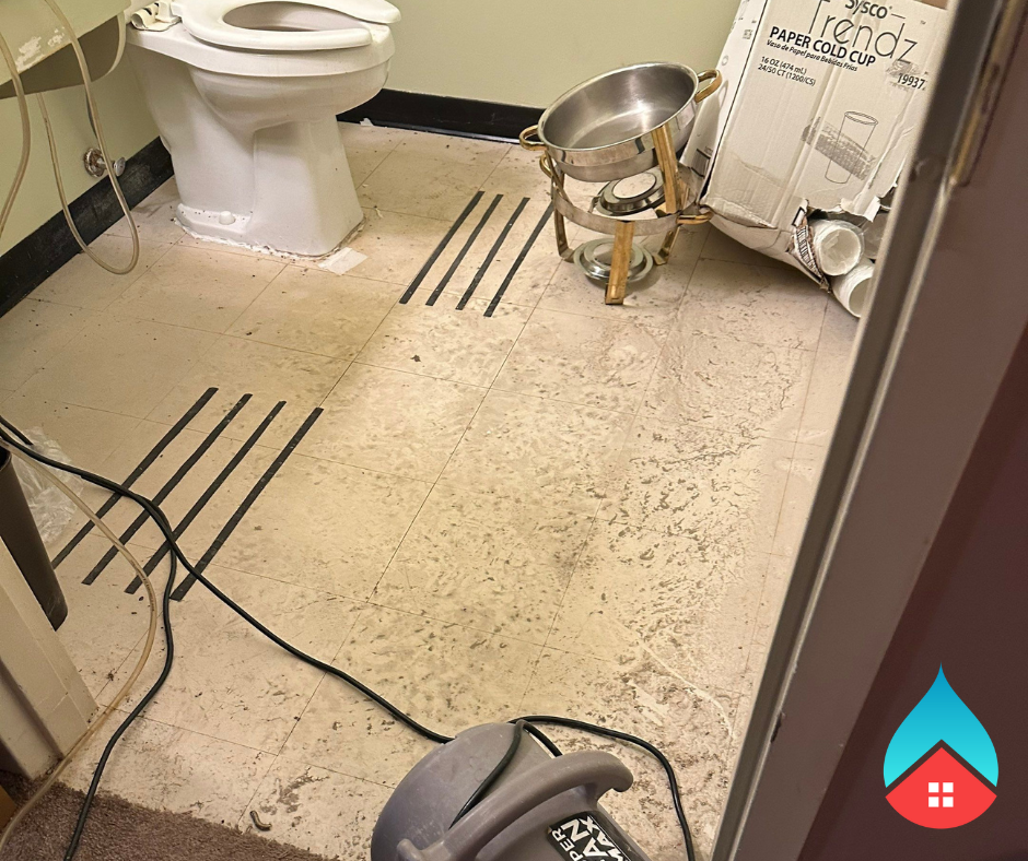 Overflowing toilet cleanup in a South Bend bathroom with contaminated water on the floor.